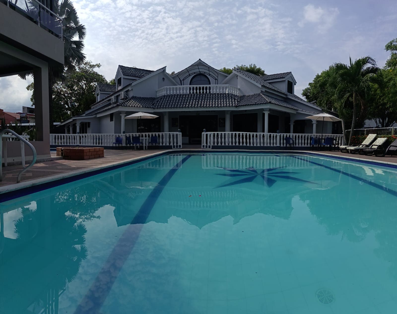 Piscina principal con zona de camastros